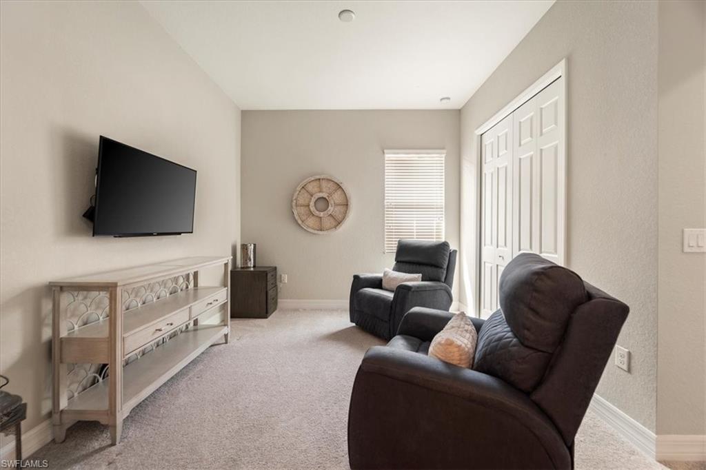 12840 Kinross Lane Naples, FL 34120 - Photo 14 of 44 a living room with furniture and a flat screen tv