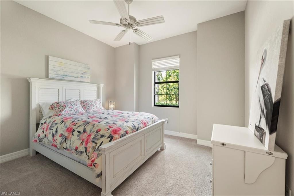 12840 Kinross Lane Naples, FL 34120 - Photo 15 of 44 a bedroom with a bed flat screen tv and window