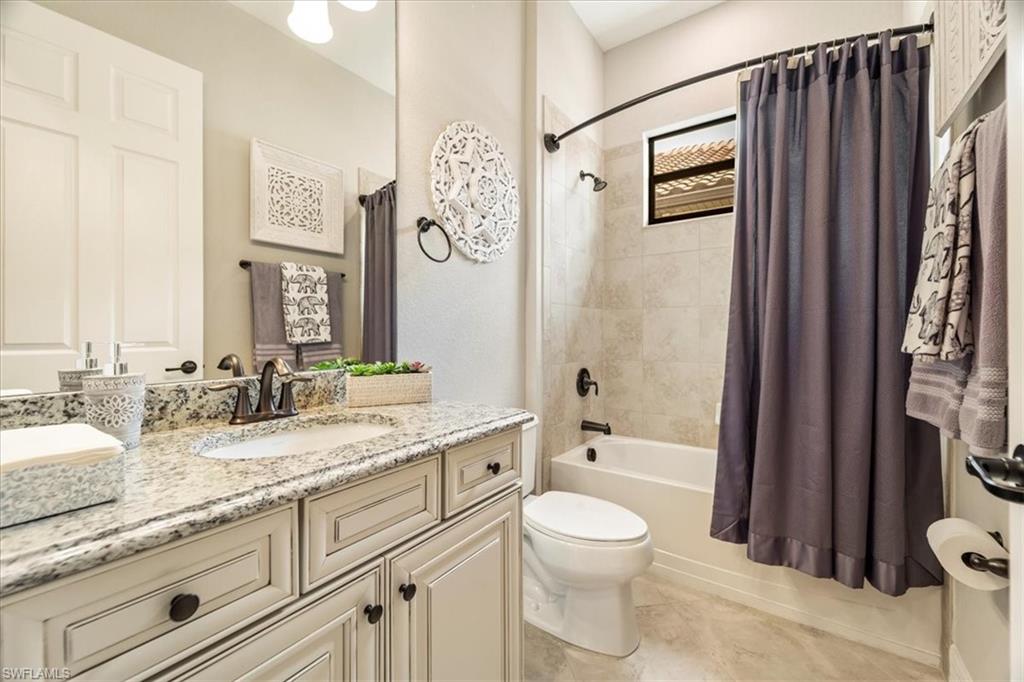 12840 Kinross Lane Naples, FL 34120 - Photo 16 of 44 a bathroom with a granite countertop sink toilet and shower