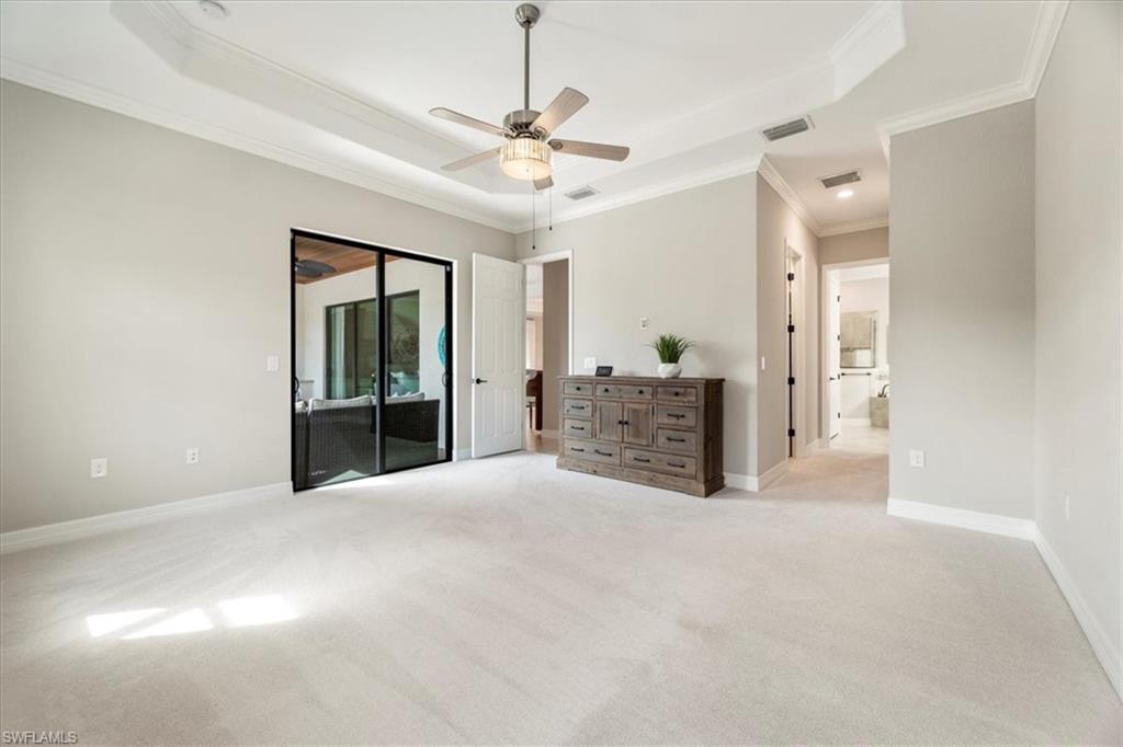 12840 Kinross Lane Naples, FL 34120 - Photo 18 of 44 a view of an empty room with a ceiling fan