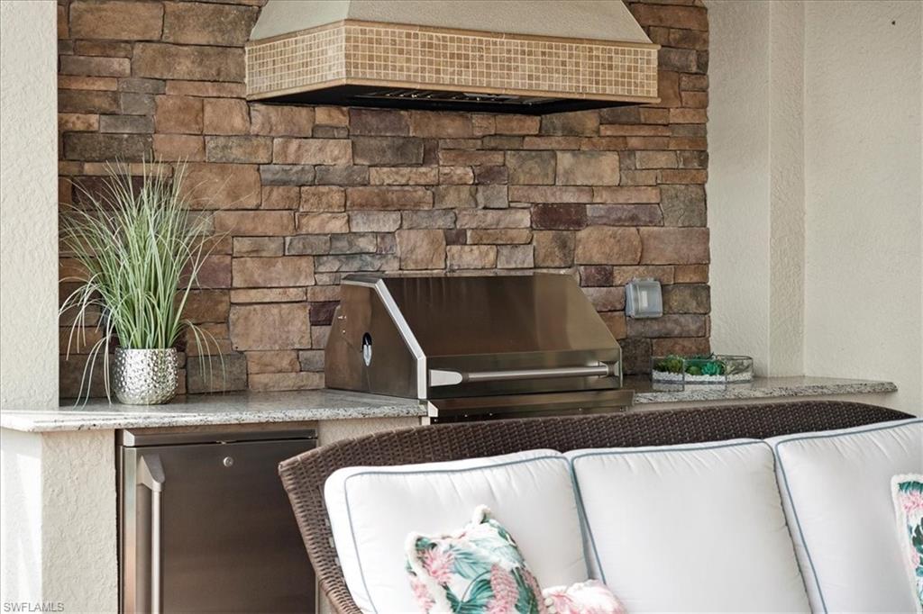 12840 Kinross Lane Naples, FL 34120 - Photo 22 of 44 a room with a granite counter tops and a potted plant