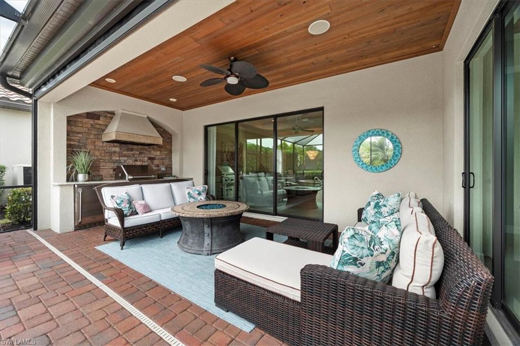 12840 Kinross Lane Naples, FL 34120 - Photo 23 of 44 a living room with furniture and a large window