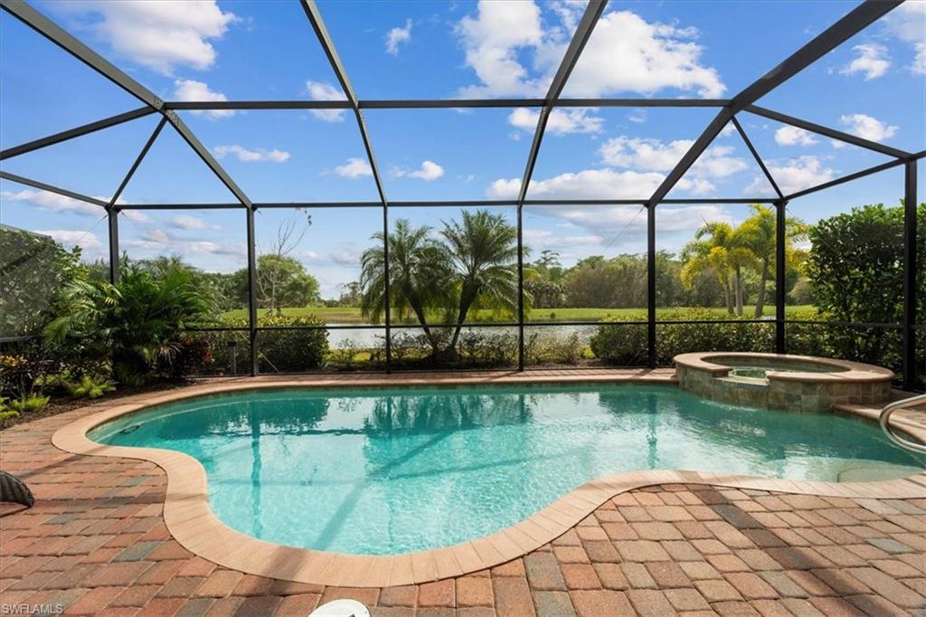 12840 Kinross Lane Naples, FL 34120 - Photo 26 of 44 a view of a swimming pool with a patio