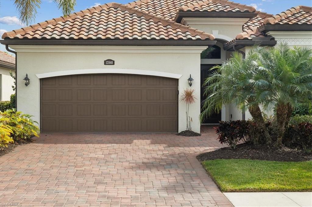 12840 Kinross Lane Naples, FL 34120 - Photo 29 of 44 a front view of a house with garden