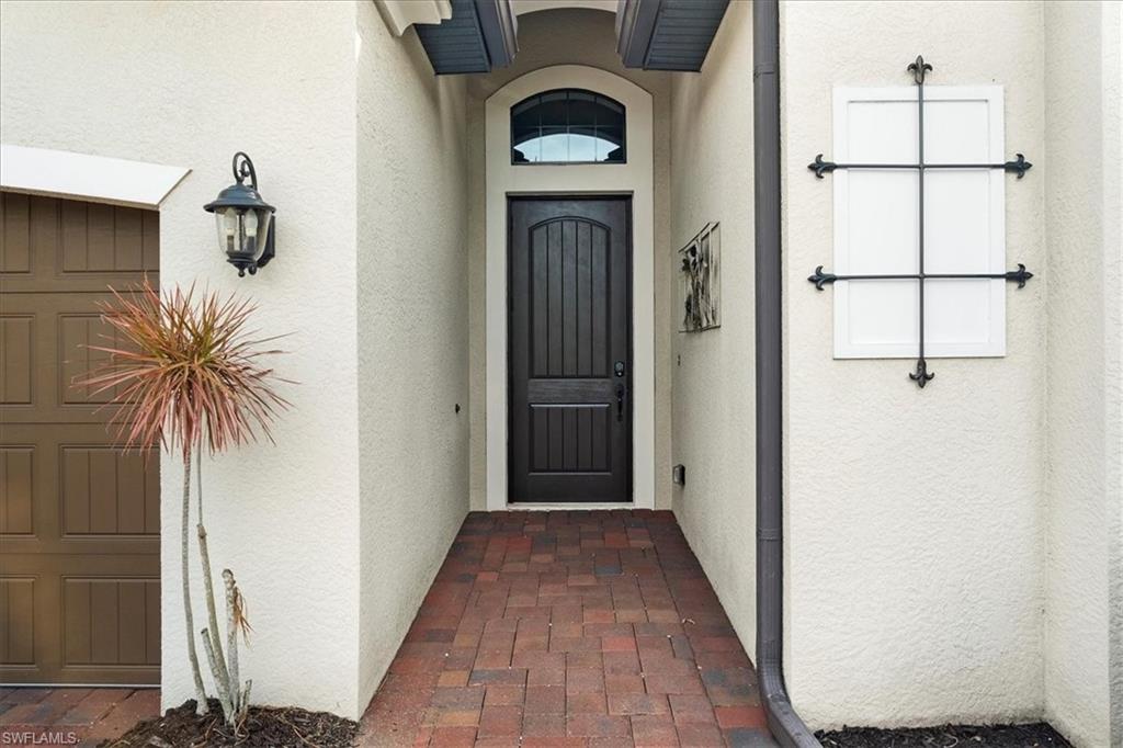 12840 Kinross Lane Naples, FL 34120 - Photo 30 of 44 a view of a hallway with wooden floor and entryway
