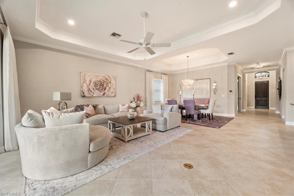 12840 Kinross Lane Naples, FL 34120 - Photo 3 of 44 a living room with furniture and a chandelier