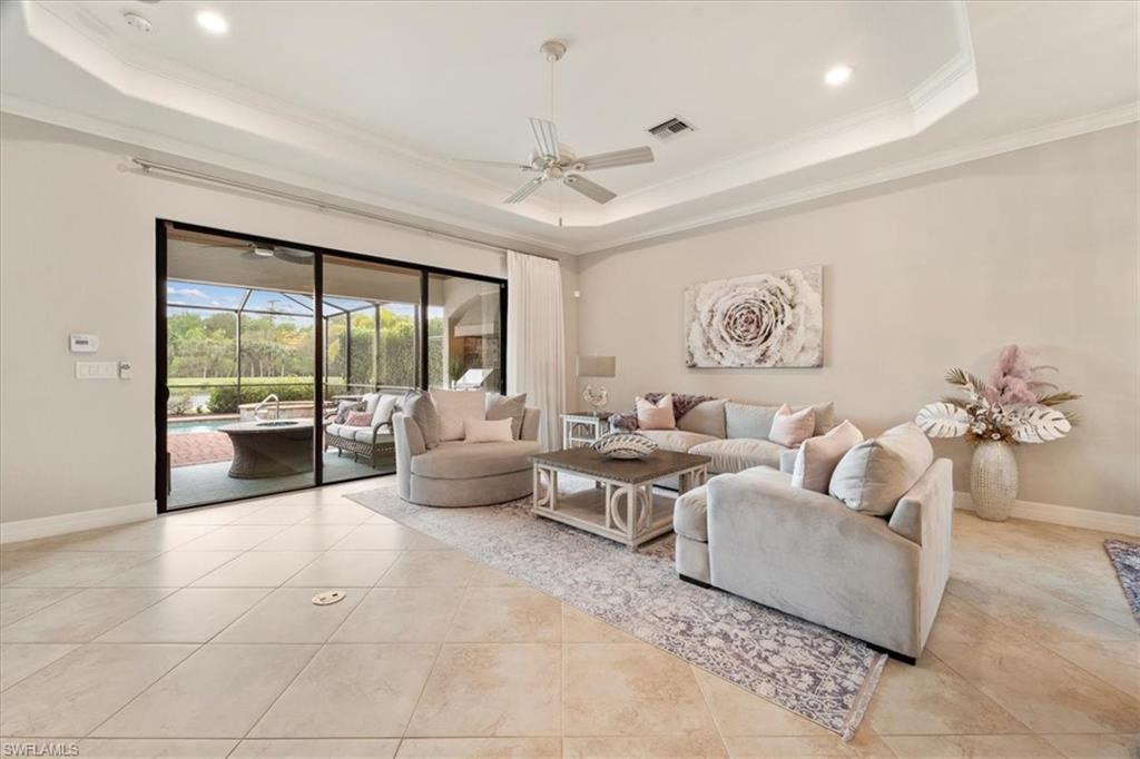 12840 Kinross Lane Naples, FL 34120 - Photo 4 of 44 a living room with furniture and a large window