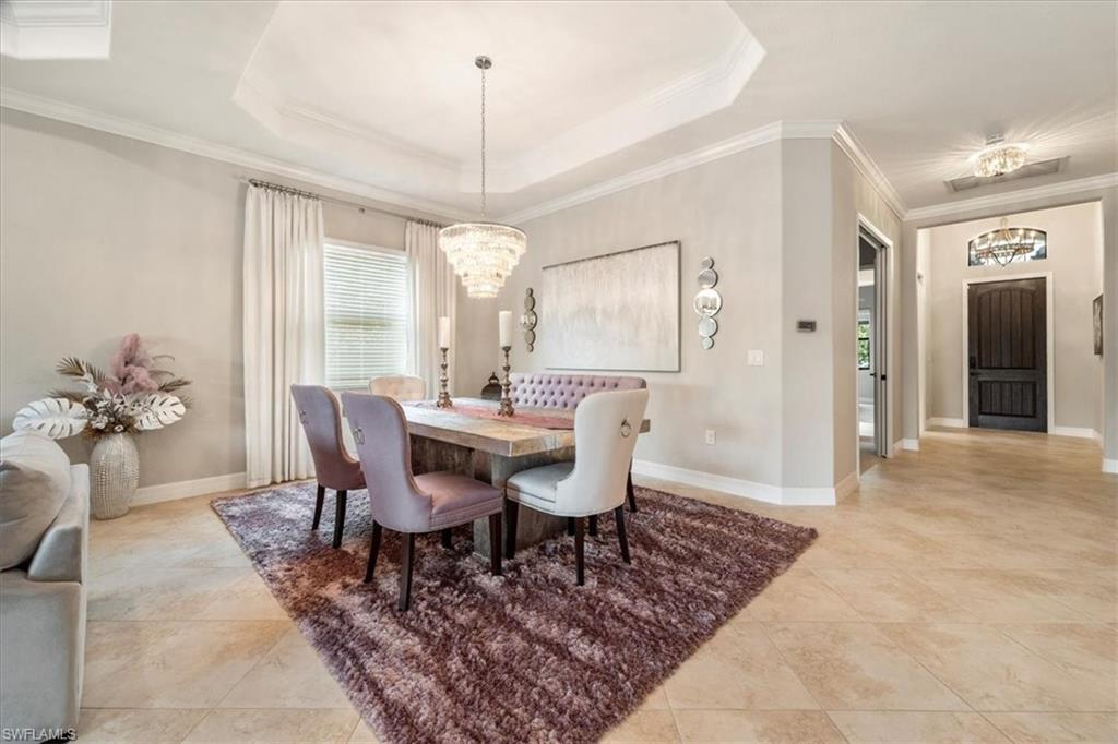 12840 Kinross Lane Naples, FL 34120 - Photo 9 of 44 a view of a dining room with furniture window and wooden floor