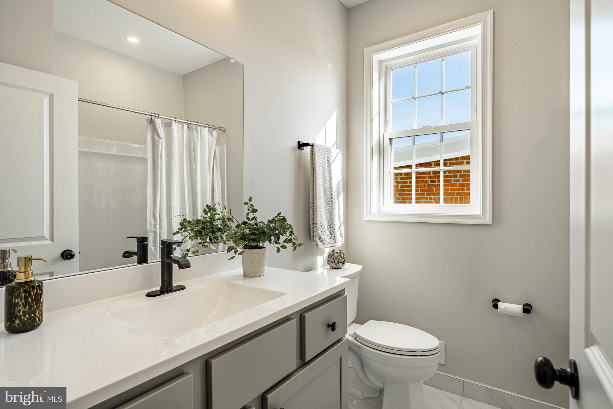 523 Grove Street Bridgeport, PA 19405 - Photo 13 of 25 a bathroom with a sink a toilet and shower