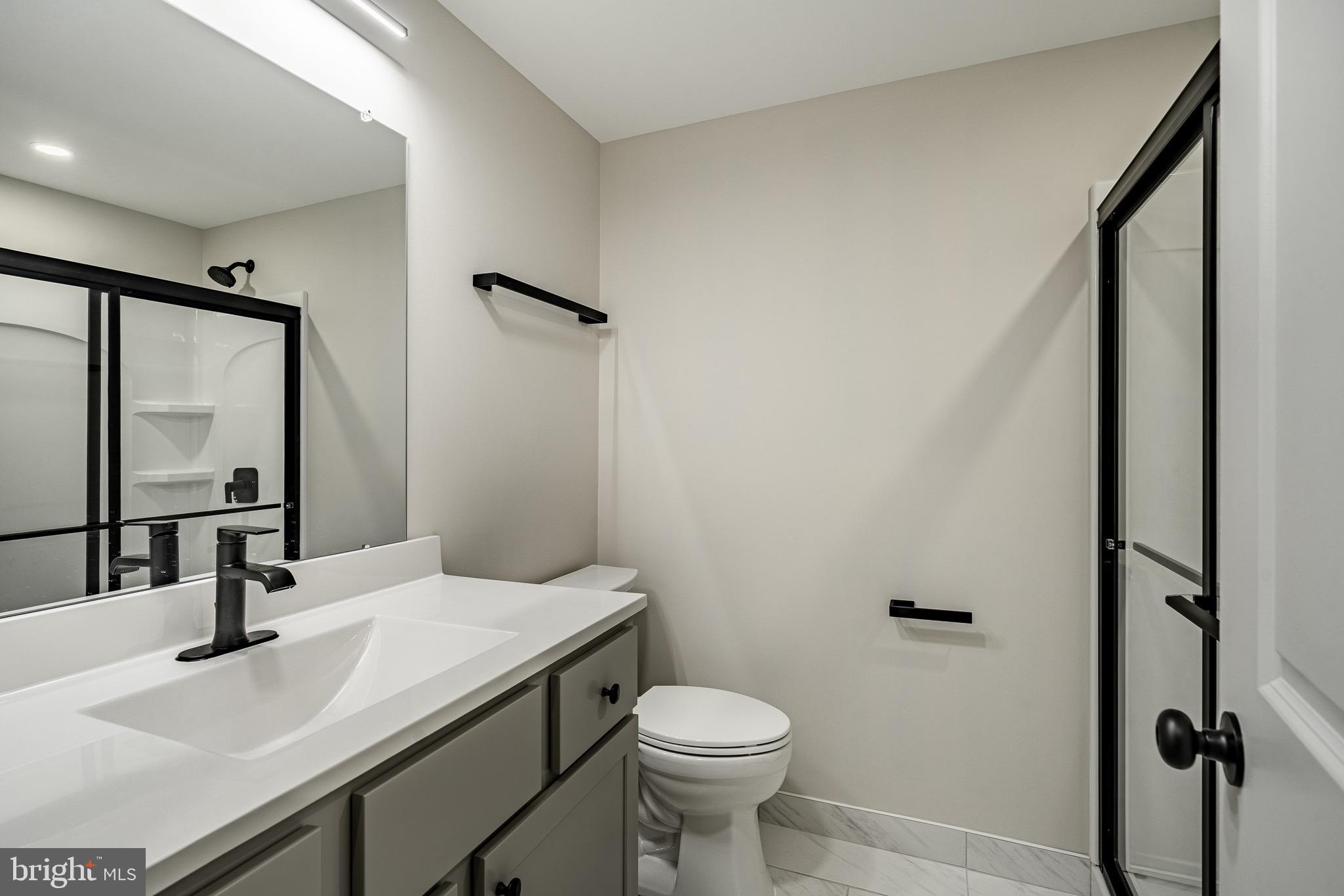 523 Grove Street Bridgeport, PA 19405 - Photo 15 of 25 a bathroom with a sink toilet and mirror