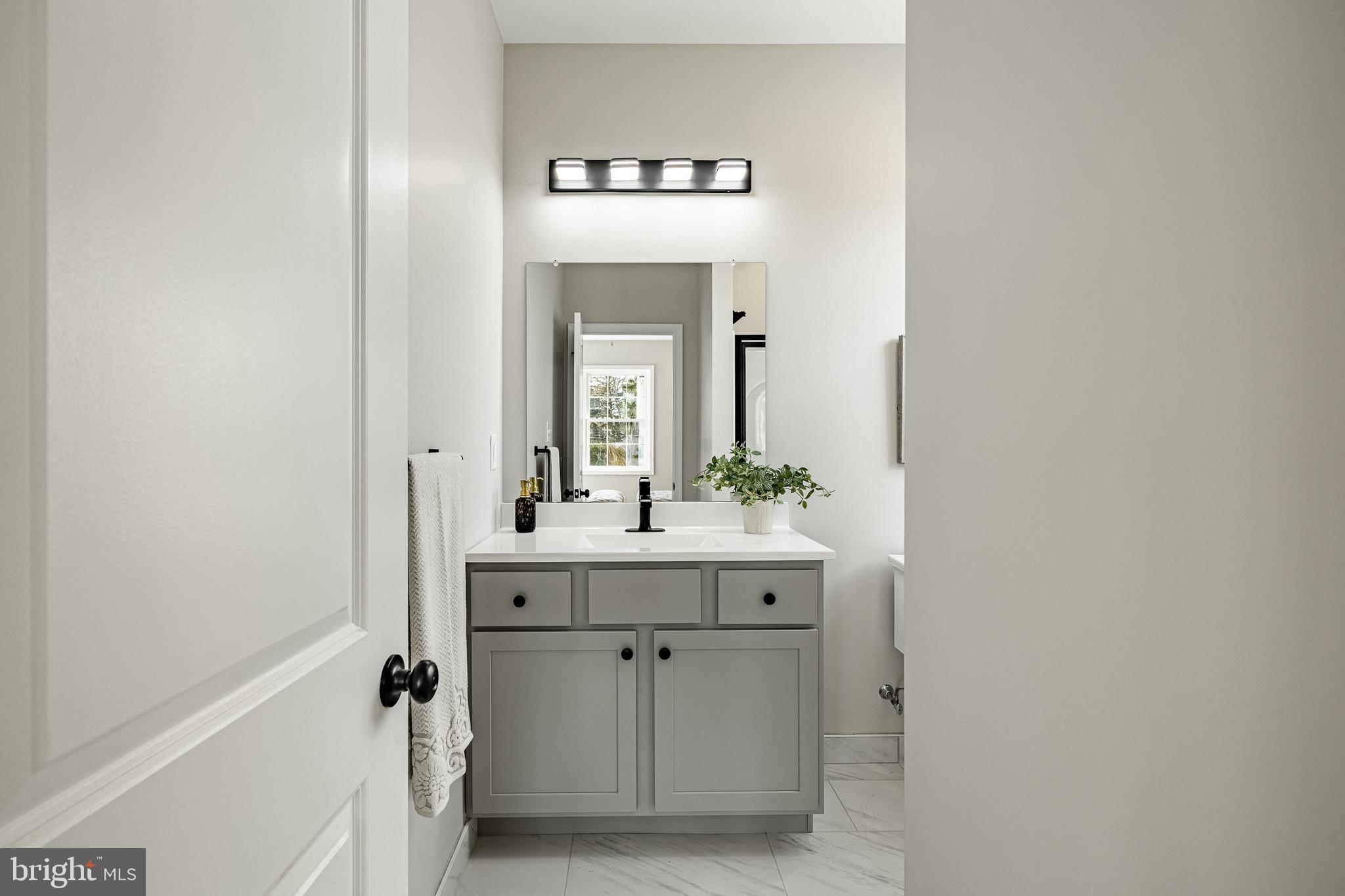 523 Grove Street Bridgeport, PA 19405 - Photo 10 of 25 a bathroom with a sink and a mirror