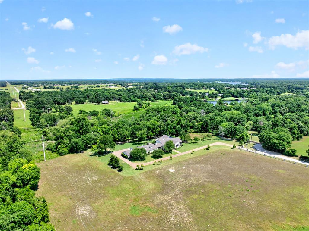 1901 Rose Pointe Athens, TX 75752 - Photo 35 of 37 Expansive parcel featuring a single-story residence with a gray shingle roof, surrounded by mature trees and open fields