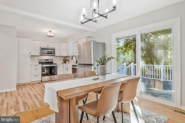 a kitchen with a refrigerator a stove top oven a sink and cabinets