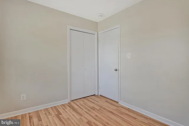 a living room with furniture a piano and a potted plant