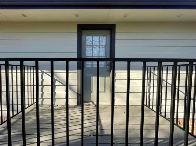 a view of balcony with wooden floor
