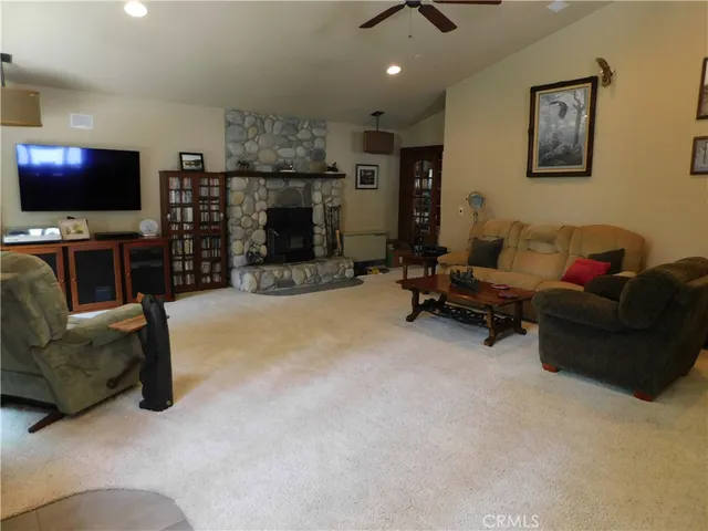 a view of a livingroom with furniture and a ceiling fan