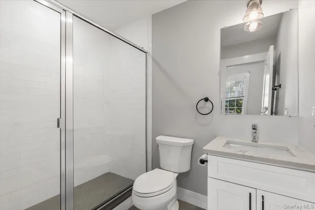 a bathroom with a toilet a sink and a mirror