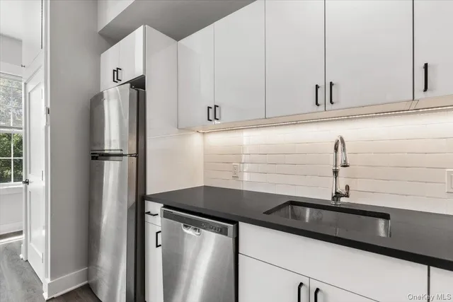 a kitchen with a sink and a refrigerator