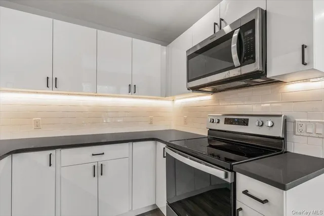 a kitchen with a stove microwave and sink