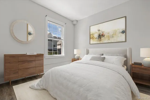 a bedroom with a bed and a painting on the wall