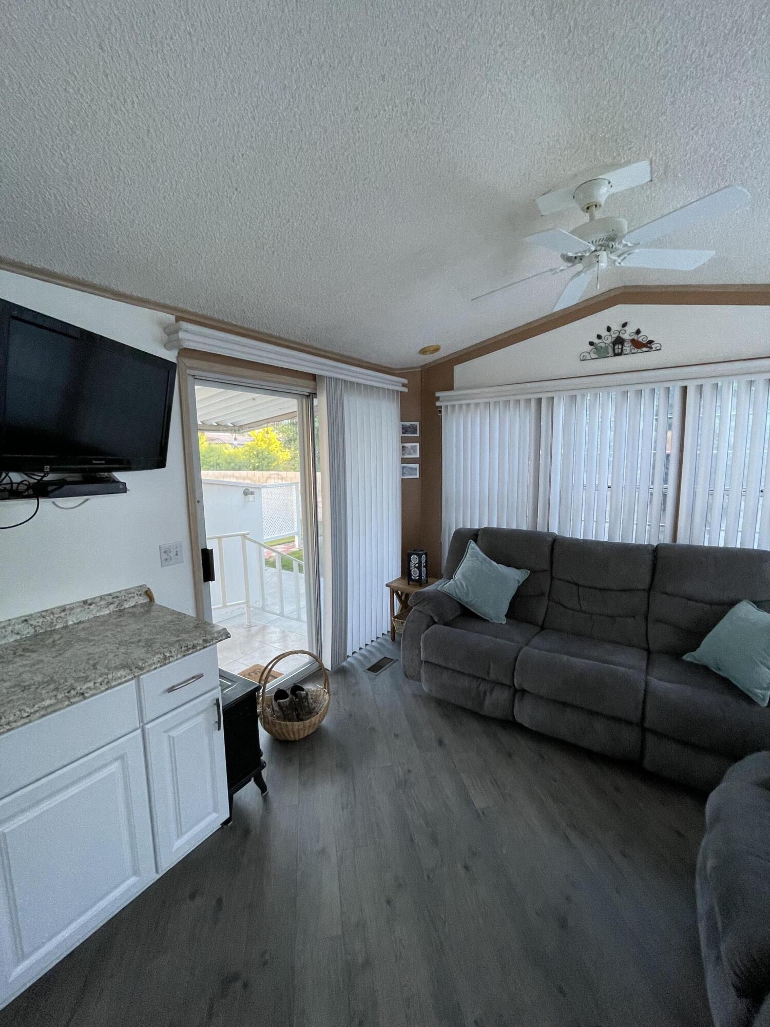 81620 Ave 49, Unit 27A Indio, CA 92201 - Photo 14 of 22 a living room with furniture and a flat screen tv