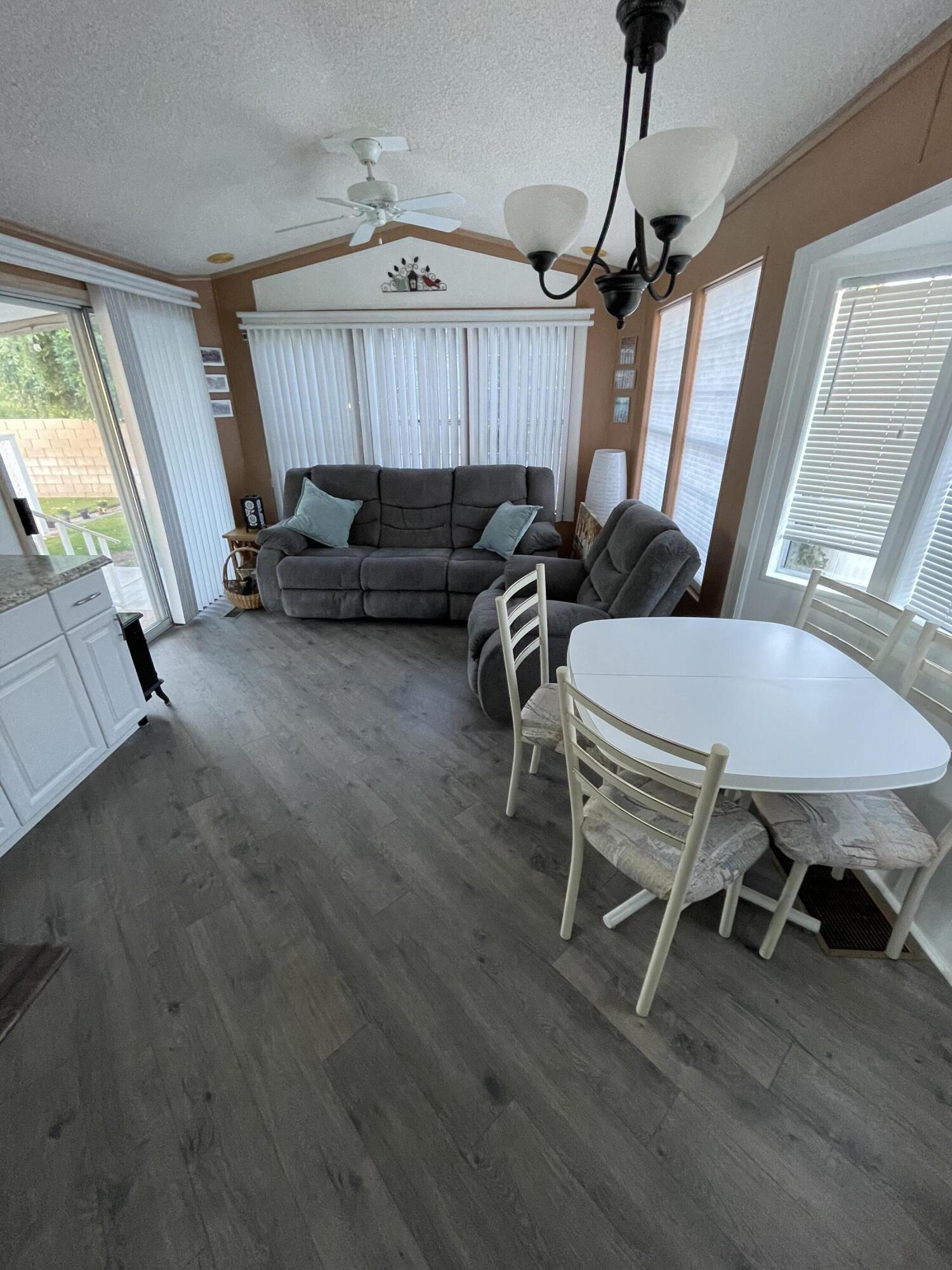 81620 Ave 49, Unit 27A Indio, CA 92201 - Photo 19 of 22 a livingroom with furniture window and wooden floor