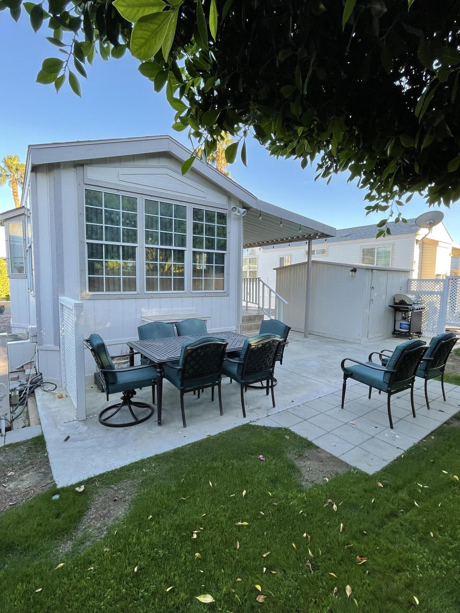 81620 Ave 49, Unit 27A Indio, CA 92201 - Photo 2 of 22 a view of a house with backyard sitting area and garden