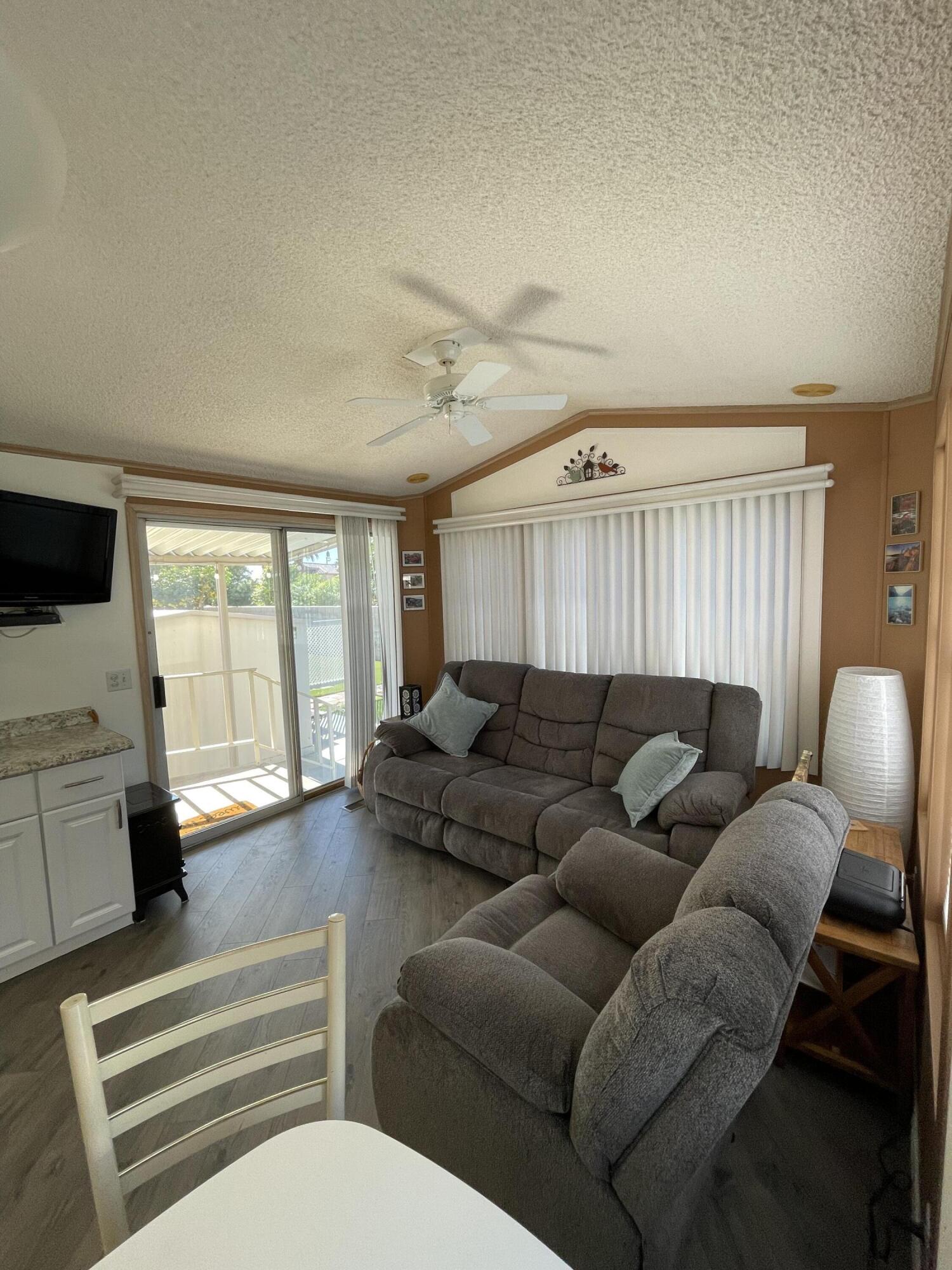 81620 Ave 49, Unit 27A Indio, CA 92201 - Photo 21 of 22 a living room with furniture and a flat screen tv