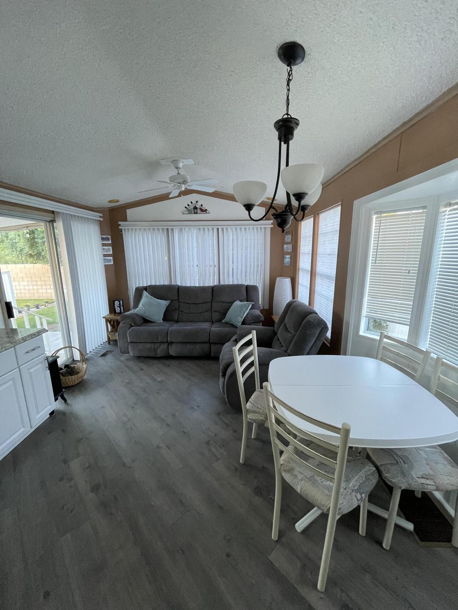 81620 Ave 49, Unit 27A Indio, CA 92201 - Photo 3 of 22 a living room with furniture a window and a chandelier
