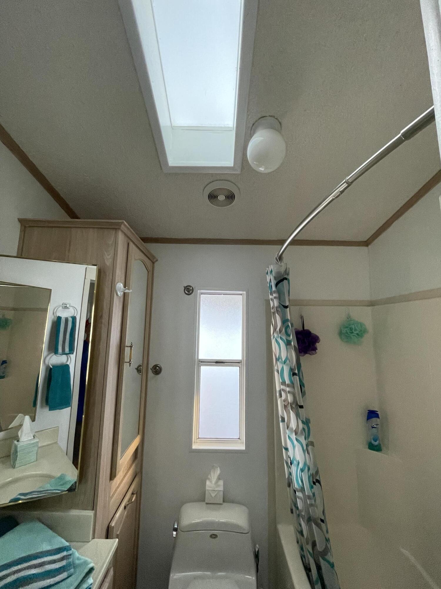 81620 Ave 49, Unit 27A Indio, CA 92201 - Photo 5 of 22 a bathroom with a sink mirror and shower