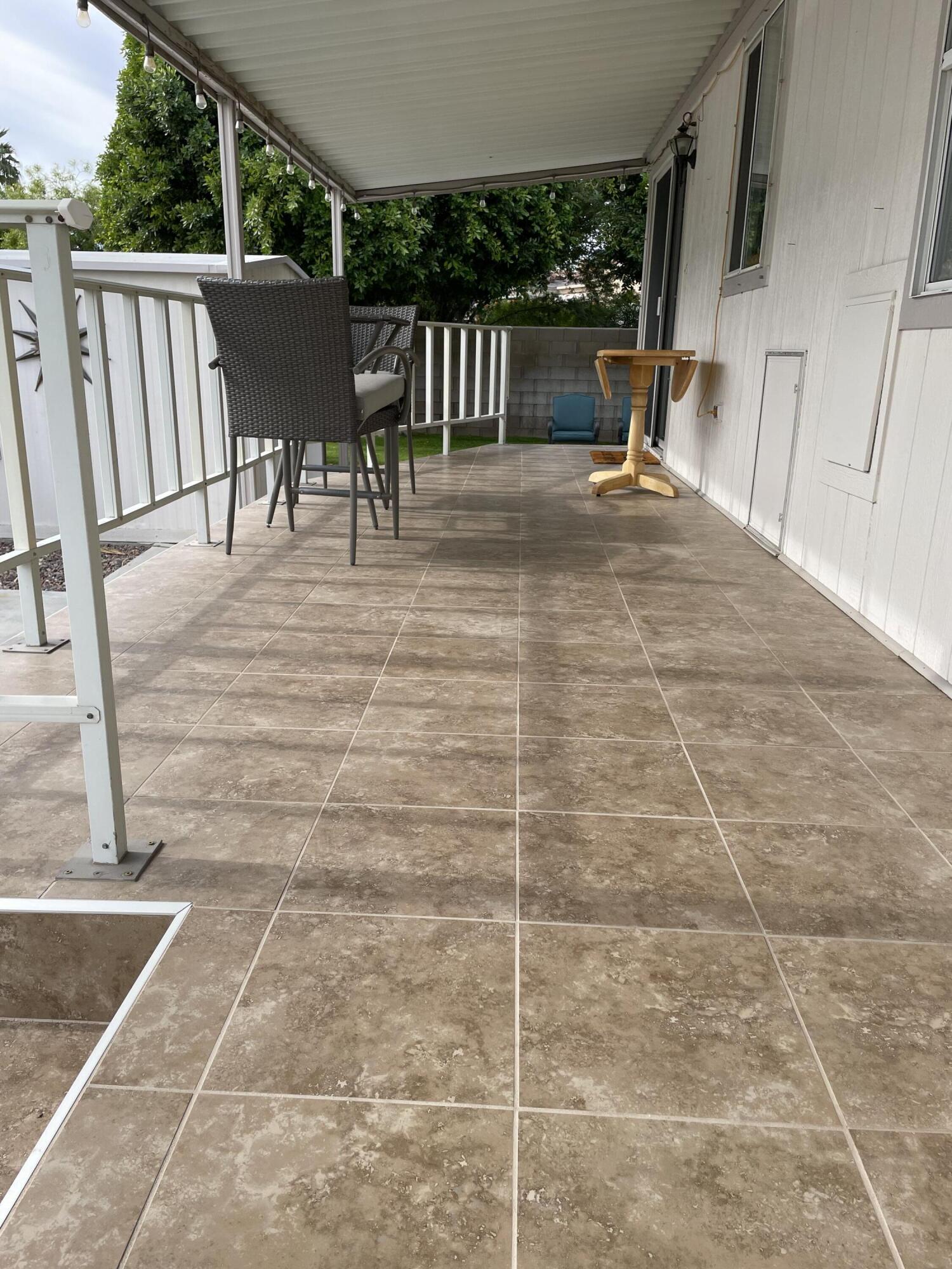 81620 Ave 49, Unit 27A Indio, CA 92201 - Photo 7 of 22 a view of a patio with a table and chairs and wooden floor
