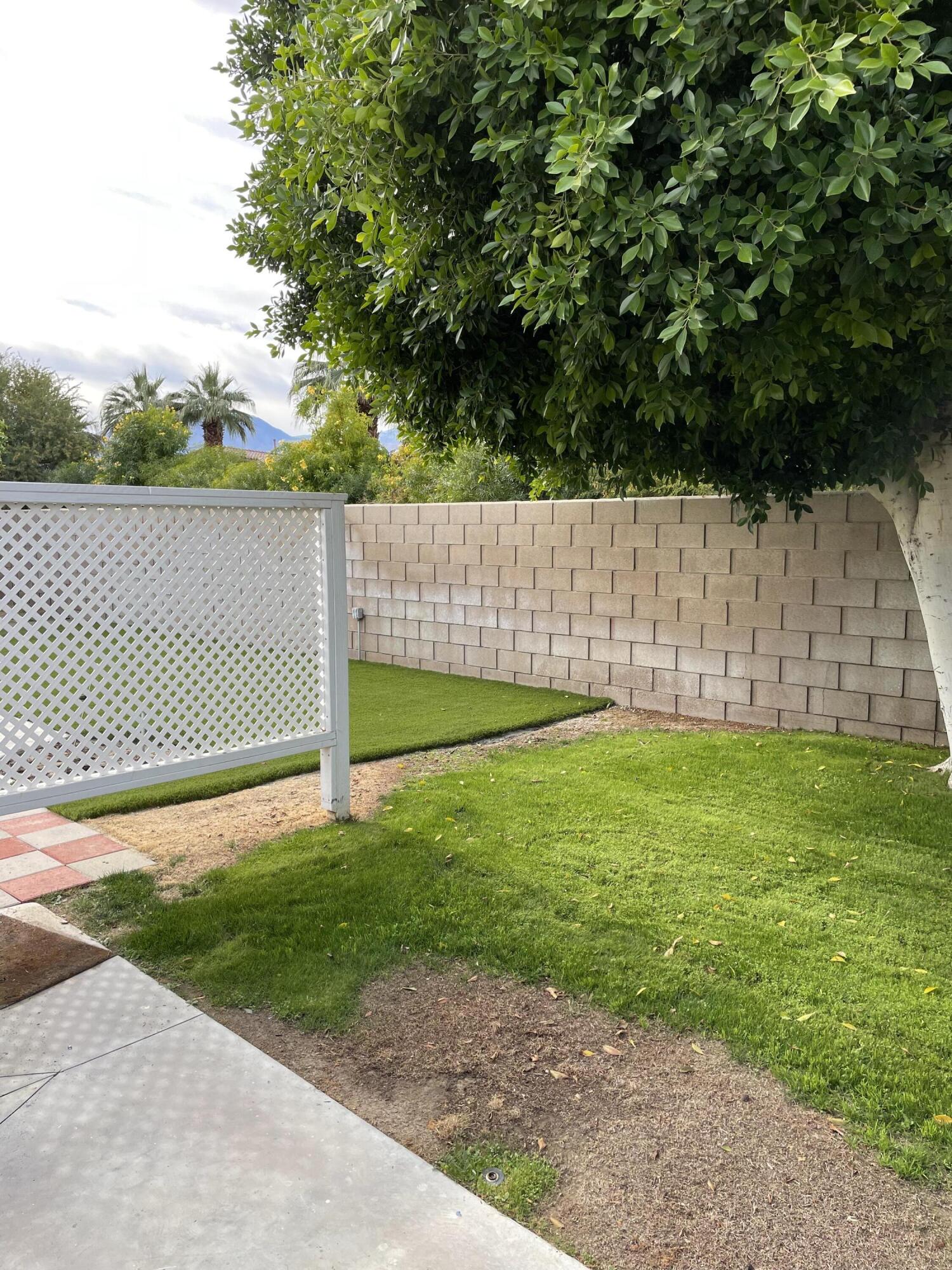 81620 Ave 49, Unit 27A Indio, CA 92201 - Photo 9 of 22 a view of a backyard with a small fence