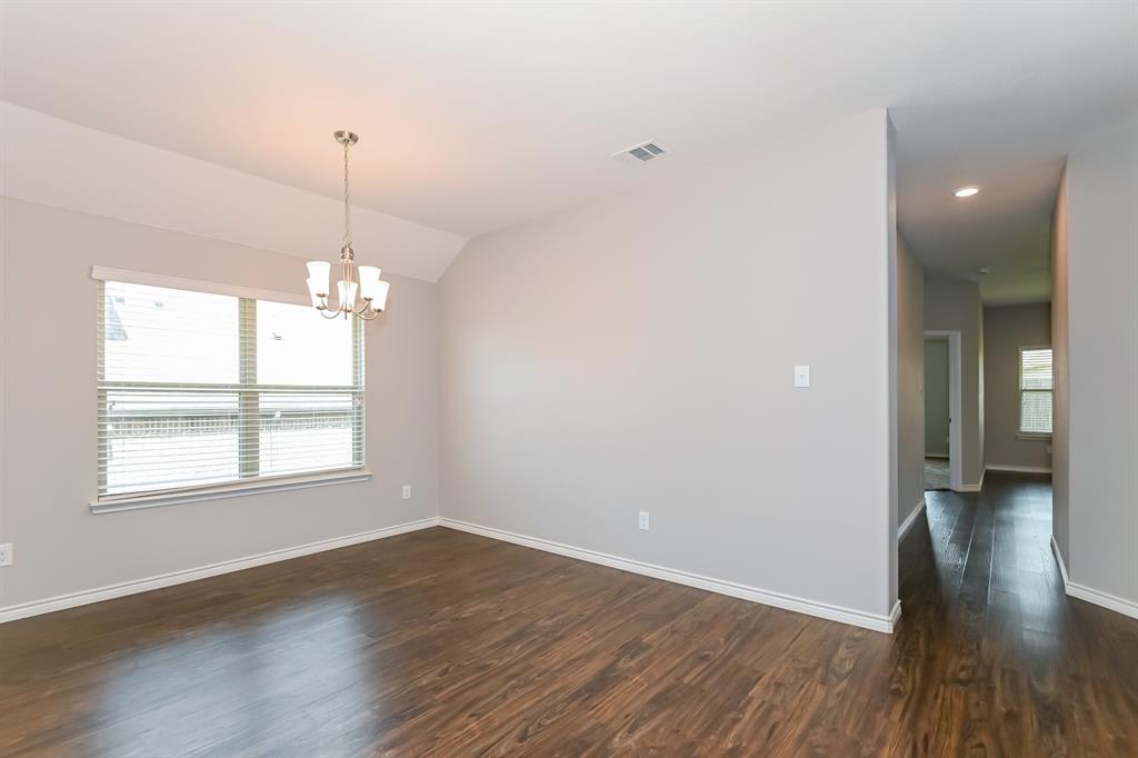571 Kara Drive Fate, TX 75087 - Photo 4 of 16 a view of empty room with wooden floor and fan