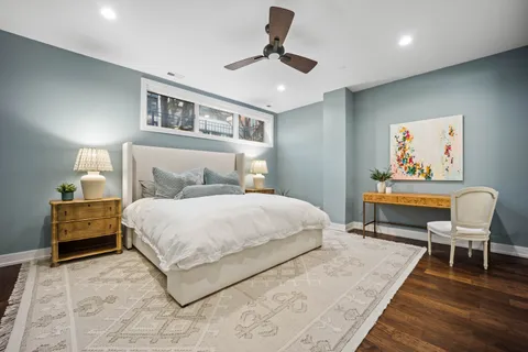 a bedroom with a large bed and a chandelier