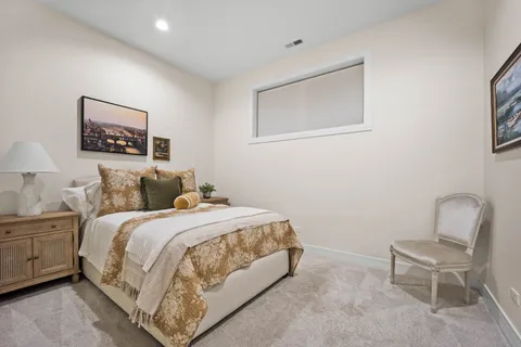 a bedroom with a bed and a painting on the wall