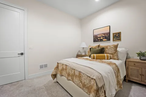 a bathroom with a granite countertop sink a toilet a mirror and shower