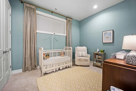 a bedroom with a bed and a lamp