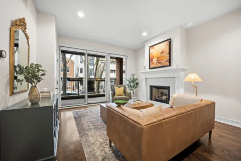 a living room with furniture a rug and a dresser