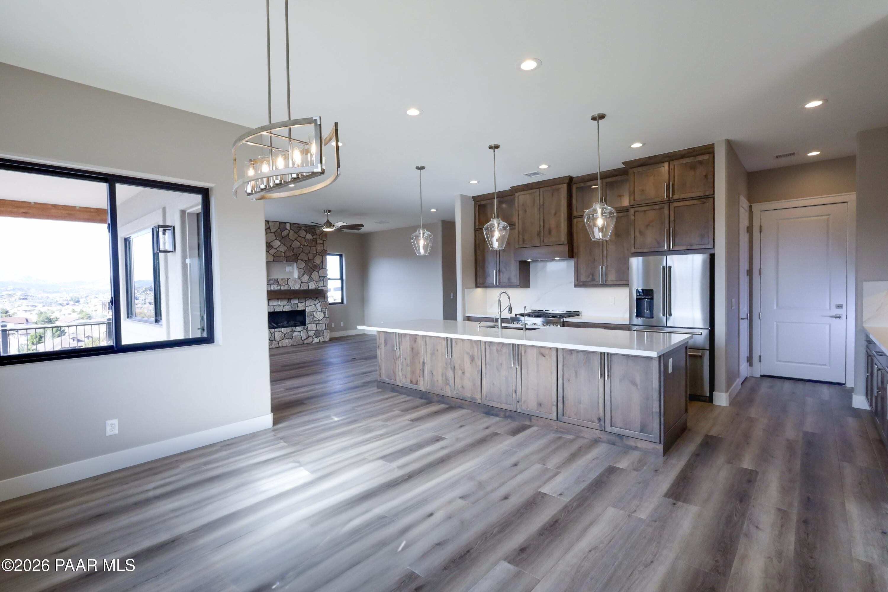 1941 Ventnor Circle Prescott, AZ 86301 - Photo 11 of 41 a large kitchen with kitchen island a large counter space a refrigerator and wooden floor