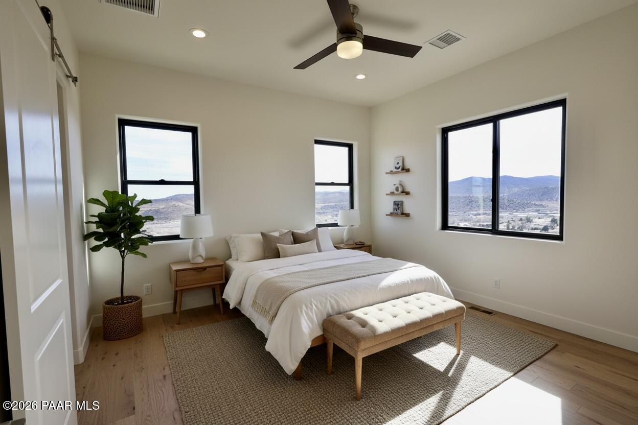 1941 Ventnor Circle Prescott, AZ 86301 - Photo 21 of 41 a bedroom with a large bed and a chandelier