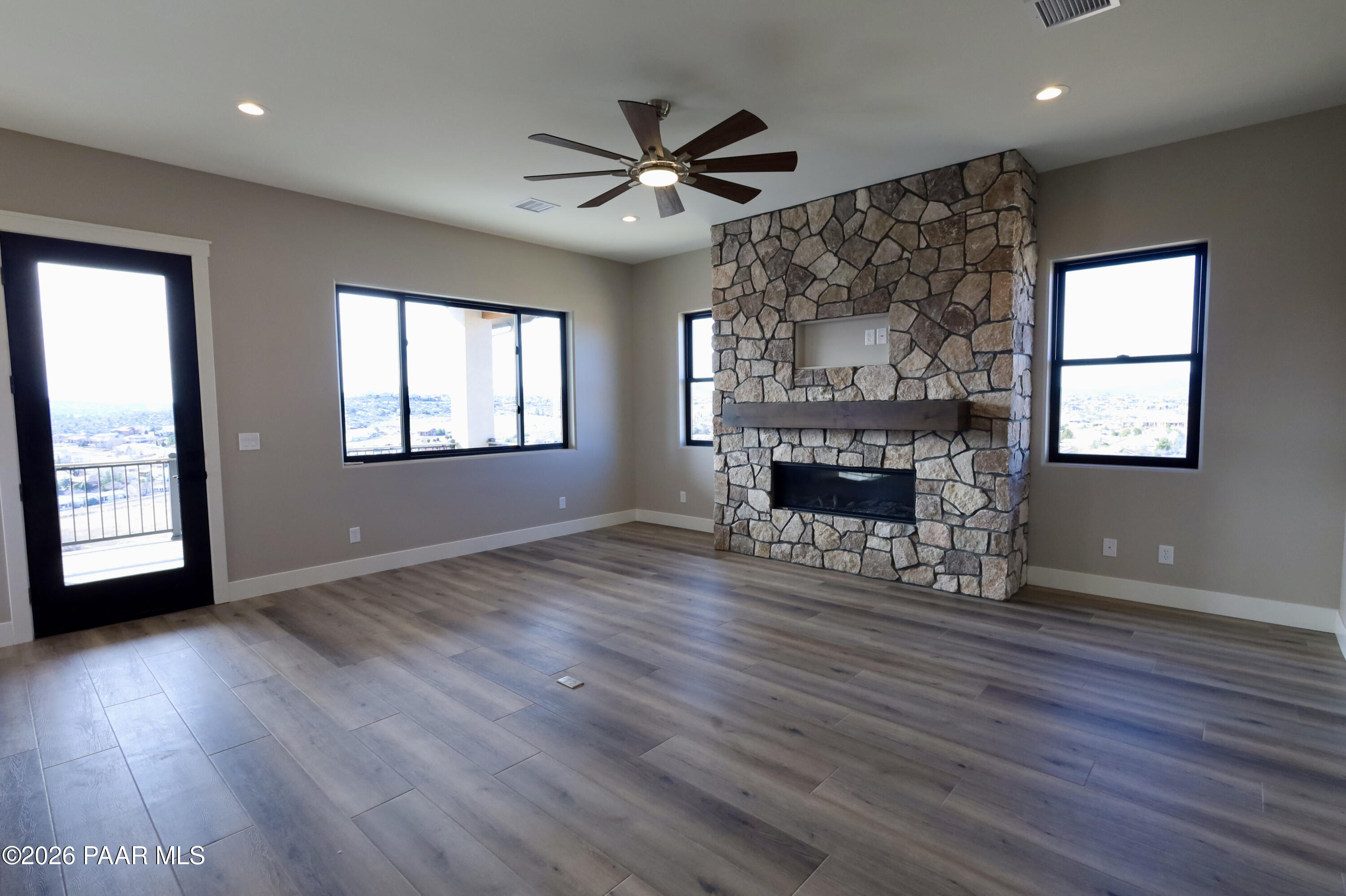 1941 Ventnor Circle Prescott, AZ 86301 - Photo 8 of 41 an empty room with windows fireplace and wooden floor