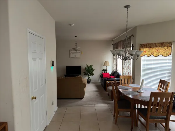 a view of a dining room with furniture and window
