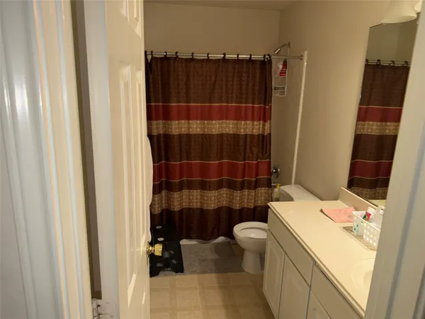 a living room with furniture and a mirror