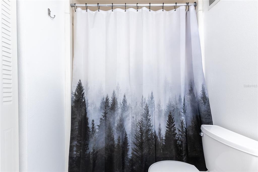 6519 West Newberry Road, Unit 805 Gainesville, FL 32605 - Photo 22 of 39 a bathroom with a toilet and a shower curtain