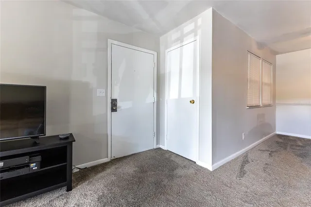 a view of a livingroom with wooden floor and a flat screen tv