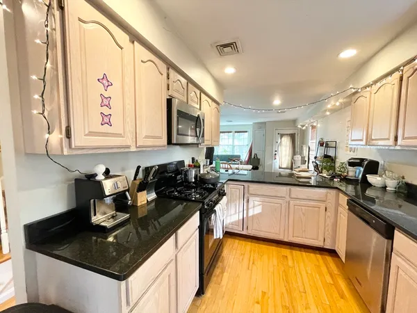 a kitchen with a sink stove and cabinets