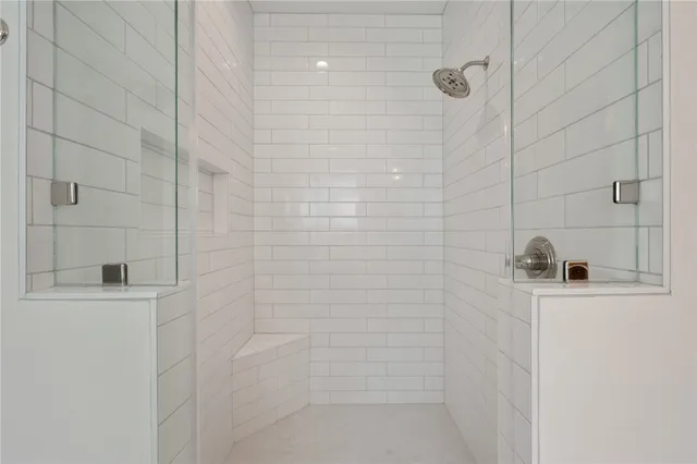 an empty room with a window and a ceiling fan