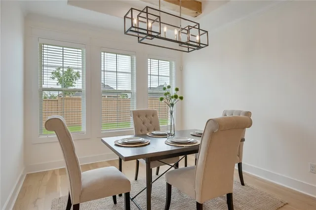 a view of a dining room with furniture and chandelier