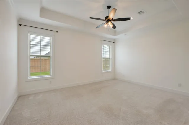 a spacious bathroom with a tub sink and mirror