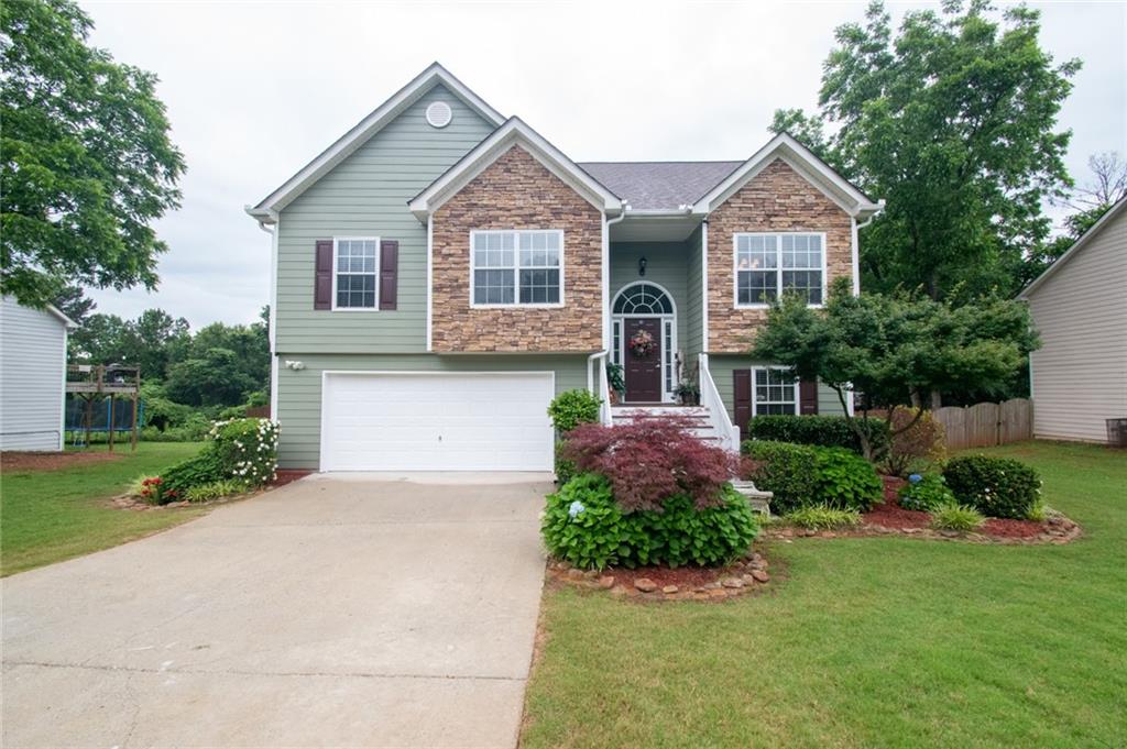 9734 Poole Road Villa Rica, GA 30180 - Photo 1 of 1 a front view of a house with a yard and garage